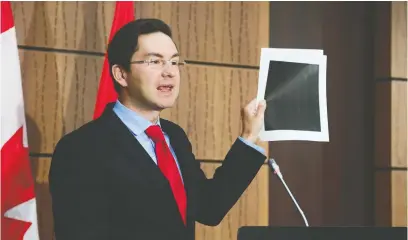  ?? SEAN KILPATRICK/THE CANADIAN PRESS ?? Conservati­ve MP Pierre Poilievre, speaking Wednesday at a news conference on Parliament Hill, holds up heavily redacted documents released by the Liberal government to a committee probing the WE affair.