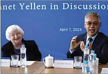  ?? TATAN SYUFLANA / AP ?? U.S. Treasury Secretary Janet Yellen, left, talks with Huang Yiping, dean of the National School of Developmen­t at Peking University on Sunday in Beijing.