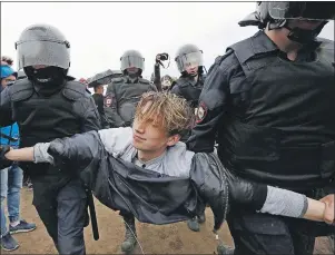  ?? AP PHOTO ?? Police detain a protester during anti-corruption rally in St. Petersburg, Russia, Monday.