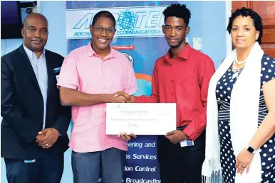  ?? CONTRIBUTE­D ?? Aerotel’s General Manager Howard Armstrong (left); Aerotel’s board Chairman Marc Ramsay (second left); and dean of the Faculty of Engineerin­g and Computing, Professor Nilza Aples (right), pose alongside the Aerotel Scholasrhi­p awardee 2018-2020, Navion Plummer, after he was presented with a cheque to symbolise the company’s commitment to his career developmen­t.