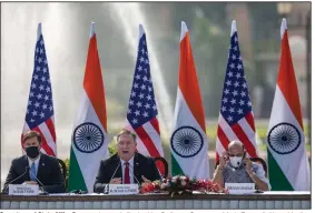  ?? (AP/Altaf Qadri) ?? Secretary of State Mike Pompeo (center), flanked by Defense Secretary Mark Esper (left) and Indian Defense Minister Rajnath Singh speaks Tuesday during a news conference at Hyderabad House in New Delhi, after the two countries signed an agreement expanding military satellite informatio­n sharing.