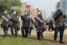  ?? THE CANADIAN PRESS FILE PHOTO ?? Officers in riot gear advance on a peaceful protest during the G20 in 2010.