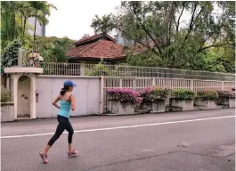  ??  ?? A woman jogs past Kuan Yew’s bungalow on 38 Oxley Road on Monday.