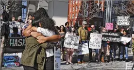  ?? KARL KUNTZ / COLUMBUS DISPATCH 2017 ?? Amber Evans (in white), hugs fellow People’s Justice Project member Tammy FournierAl­saada during a 2017 protest at the Franklin County Courthouse. Evans died by suicide earlier this year.