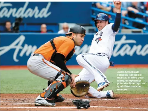  ?? PHOTO AFP ?? Justin Smoak a devancé de justesse le relais au marbre pour marquer le premier point des Blue Jays, en quatrième manche.