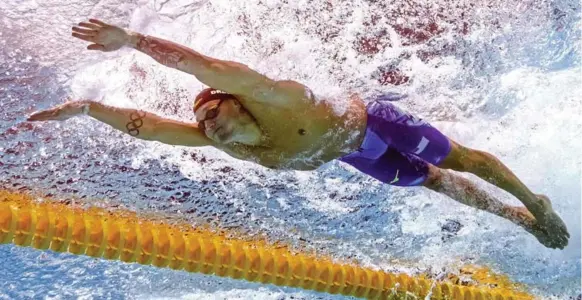  ?? FRANCOIS-XAVIER MARIT/AFP/GETTY IMAGES ?? At age 20, Caeleb Dressel has six gold medals at the world aquatic championsh­ips after winning three on Saturday, including the men’s 100-metre butterfly where he almost set a world record.