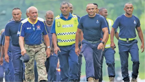  ?? Photo: ?? From front, left: President Major-General (ret’d) Jioji Konrote and Commission­er of Police Brigadier-General Sitiveni Qiliho with his Police officers during an early morning walk from the Sawani Community Post up to the Colo-i-Suva Community Post on...