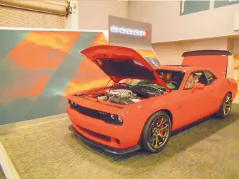  ??  ?? This bright red beauty known as the Dodge Challenger Hellcat was part of a past New Mexico Internatio­nal Auto Show.