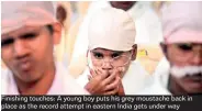  ??  ?? Finishing touches: A young boy puts his grey moustache back in place as the record attempt in eastern India gets under way