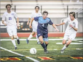  ?? PHOTO BY DARNELL MARBURY ?? La Plata’s Owen Butler works with the ball in front of Leonardtow­n’s Kobe Harris during the SMAC boys soccer championsh­ip game at North Point on Tuesday night. Butler scored La Plata’s lone goal in a 2-1 loss to the Raiders.