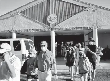  ?? GABBY JONES/THE NEW YORK TIMES ?? People exit from a ferry terminal last month in Saint Thomas in the U.S. Virgin Islands.