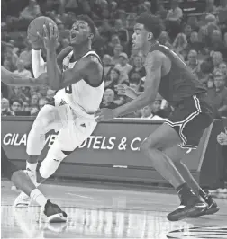  ??  ?? Arizona State's Luguentz Dort drives past Long Beach State's KJ Byers during the first half at Wells Fargo Arena in Tempe on Monday.