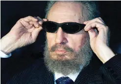  ??  ?? This file photo taken on Nov 16, 1999 shows Castro trying on a pair of sunglasses as he talks to the media in Havana during the IX Iberoameri­can Summit.