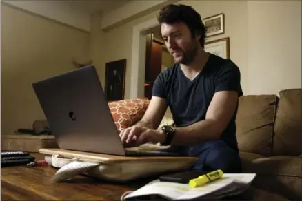  ?? RICHARD DREW, THE ASSOCIATED PRESS ?? Journalist Michael Weiss works on his laptop in his apartment on New York’s Upper West Side. Weiss is one of at least 200 journalist­s worldwide who have been targeted by the Russian government-aligned hacking group widely known as Fancy Bear.