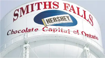  ?? KIER GILMOUR/FILES ?? The water tower in Smiths Falls was a testament to Hershey’s role as the town’s major employer. About 600 jobs were lost when the plant shut down in 2007. Canopy Growth now uses the factory building as one of its major marijuana growing facilities.