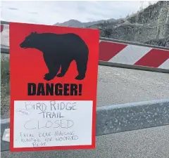  ?? AP ?? A sign warns people that the trail head is closed on Monday after a fatal bear mauling at Bird Ridge Trail in Anchorage, Alaska.