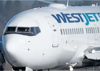  ?? THE CANADIAN PRESS FILES ?? A pilot taxis a Westjet Boeing 737-700 at Vancouver Internatio­nal Airport. WestJet CEO Gregg Saretsky says the airline’s low-cost carrier Swoop will mostly fly different routes, but may be used to supplement the larger airline.