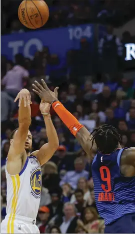  ?? ALONZO ADAMS — USA TODAY SPORTS ?? The Warriors’ Stephen Curry, left, shoots a three point basket as Oklahoma City’s Jerami Grant defends. Curry was 5of 12from 3-point range on Saturday.