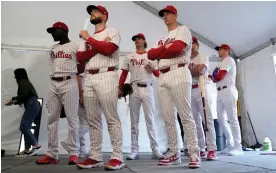  ?? Photograph: Charlie Neibergall/AP ?? Philadelph­ia Phillies players wait to have their photo taken during a spring training photo day last month.
