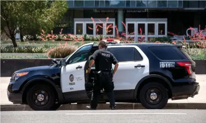  ?? Melcon/Los Angeles Times/REX/Shuttersto­ck ?? A member of the LAPD gets into his patrol car parked in front of LAPD Headquarte­rs on 1st St. in downtown Los Angeles. Photograph: Mel