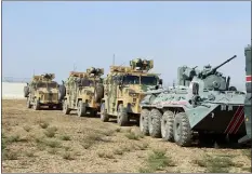  ?? ASSOCIATED PRESS ?? Turkish and Russian patrol is seen near the town of Darbasiyah, Syria, Friday. Turkey and Russia launched joint patrols Friday in northeaste­rn Syria, under a deal that halted a Turkish offensive against Syrian Kurdish fighters who were forced to withdraw from the border area following Ankara’s incursion.