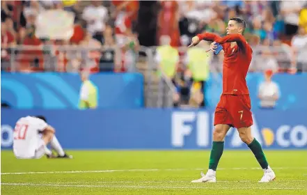 ?? FRANCISCO SECO/ASSOCIATED PRESS ?? Portugal’s Cristiano Ronaldo gestures to fans at the end of Monday’s Group B match. Ronaldo failed to convert a penalty kick and Portugal settled for a 1-1 draw with Iran. The result gave Portugal second place in its group and set up a round-of-16 match against Uruguay.