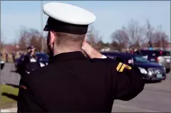  ?? CP PHOTO CHRIS YOUNG ?? A member of the Canadian Armed Forces joins the honour guard as they stand in salute as hearses arrive as part of a procession paying tribute to six members of the Canadian Armed Forces who died in a helicopter crash, at a Toronto coroners office on Wednesday.