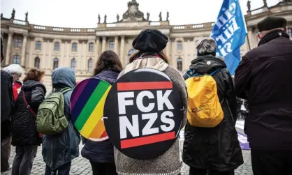  ??  ?? A leftwing counter-protester with a banner reading ‘FCK NZS’ takes part in a demonstrat­ion against the march of the far-right group ‘Reichsbuer­ger’ in Berlin, Germany, on 9 November. Photograph: Omer Messinger/EPA