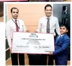  ??  ?? Thigalolip­avan Mahendran of Jaffna Hindu Primary School his cheque from DFCC’S Anton Arumugam, Vice President - Liabilitie­s &amp; Trade Business Developmen­t and Nuwan Medonza - Product Champion