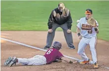  ?? LANDSBERGE­R/ THE OKLAHOMAN] ?? Little Rock's Nathan Lyons (6) dives back to first base as Oklahoma State's Alix Garcia (42) awaits the throw from his pitcher in Wednesday's home opener at O'Brate Stadium in Stillwater. [CHRIS