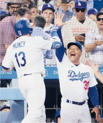  ?? MARK J. TERRILL/AP ?? Manager Dave Roberts on the Dodgers’ quest for a repeat World Series title. “I expect us to be at the top.”