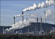  ?? MARTIN MEISSNER - ASSOCIATED PRESS ?? In this Jan. 16, 2020, file photo, an uniper coal-fired power plant and BP refinery steam beside a wind generator in Gelsenkirc­hen, Germany.