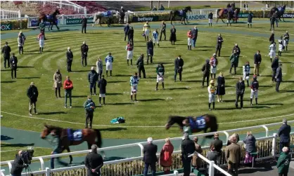  ??  ?? A two-minute silence for the death of Prince Philip during day two of the Aintree Grand National meeting. Photograph: Tom Jenkins/The Guardian