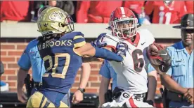  ?? Dale Zanine/USA TODAY Sports ?? Georgia Bulldogs running back Kenny McIntosh (6) runs past Georgia Tech Yellow Jackets defensive back Miles Brooks (20) to score a touchdown during the second half at Bobby Dodd Stadium.