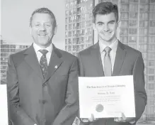  ??  ?? Herman Van Ommen, president of the Law Society of B.C., presents Reynolds Secondary student Sylvan Lutz with his essay-contest award.