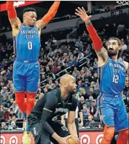  ?? [AP PHOTO/JIM MONE] ?? Minnesota's Taj Gibson, center, tries to get in position for a shot while being defended by Oklahoma City's Russell Westbrook, left, and Steven Adams during Tuesday night's NBA game in Minneapoli­s.