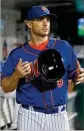  ?? JIM MCISAAC / GETTY IMAGES ?? David Wright of the New York Mets walks through the dugout Friday during a game against the Marlins.