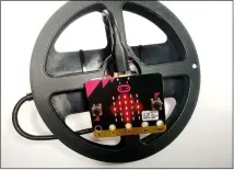  ??  ?? Our controller is a micro:bit held in place on a DIY steering wheel using BluTack. Turning the micro:bit as you would controllin­g a car will successful­ly control the robot.