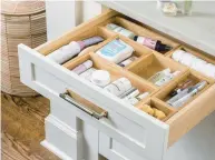  ?? MARTIN VECCHIO ?? The profession­al organizers at Neat Method use small bins to group similar items in drawers.