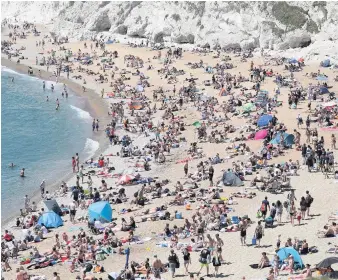  ??  ?? People fill the beach at Durdle Door despite Dorset Council announcing that the beach was closed to the public on May 31. Right, people at the beach in Bournemout­h on June 2 and top right, cars parked in the car park at Durdle Door on May 30