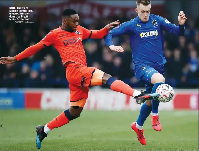  ?? PICTURES: PA Images ?? DUEL: Millwall’s Mahlon Romeo, left, and AFC Wimbledon’s Joe Pigott battle for the ball