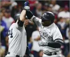  ?? THE ASSOCIATED PRESS ?? Yankees’ Didi Gregorius, right, is congratula­ted by Gary Sanchez after Gregorius hit a solo home run off Indians starting pitcher Corey Kluber during Game 5 of the ALDS on Wednesday.