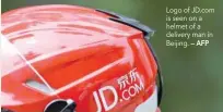  ?? — AFP ?? Logo of Jd.com is seen on a helmet of a delivery man in Beijing.