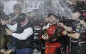  ?? TERRY RENNA — THE ASSOCIATED PRESS ?? Austin Dillon celebrates with his team and his grandfathe­r, Richard Childress, left, in Victory Lane after winning the NASCAR Daytona 500 Cup series auto race at Daytona Internatio­nal Speedway Sunday. With Dillon’s victory in the famed No. 3 and Bubba...