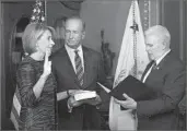  ?? Olivier Douliery Abaca Press ?? BETSY DEVOS is sworn in as Education secretary by Vice President Mike Pence on Tuesday.