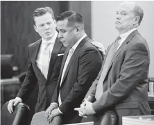  ?? Melissa Phillip / Staff photograph­er ?? Defense attorneys Cordt Akers, left, and Brock Akers, right, with Marco Carrizales. “He is a good cop,” said Akers.