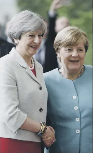  ?? PICTURE: AP PHOTO/MICHAEL SOHN. ?? CONSTRUCTI­VE START: Theresa May is welcomed by German Chancellor Angela Merkel prior to a gathering of European leaders on the G20 summit in the chanceller­y in Berlin yesterday.