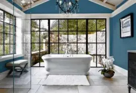  ?? TRINETTE REED PHOTOGRAPH­Y ?? “Skipping Stones,” shown here in an expansive bathroom, is Dunn-Edwards’s color of the year.