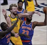  ?? MICHAEL CONROY - STAFF, AP ?? Indiana Pacers forward Domantas Sabonis (11) passes between New York Knicks center Mitchell Robinson (23) and forward Julius Randle (30) during the first half of an NBA basketball game in Indianapol­is, Wednesday, Dec. 23, 2020.
