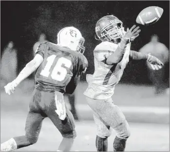  ?? PHOTOS BY DALE L. ANDERSON / SPECIAL TO THE COMMERCIAL APPEAL ?? Pass intended for St. George’s running back McCarthy Robinson is almost intercepte­d by Donelson Christian’s Shannon Fayne.